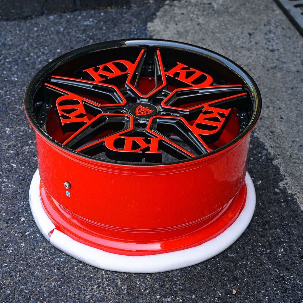 Close-up of RB-01 forged wheel spokes in black and red