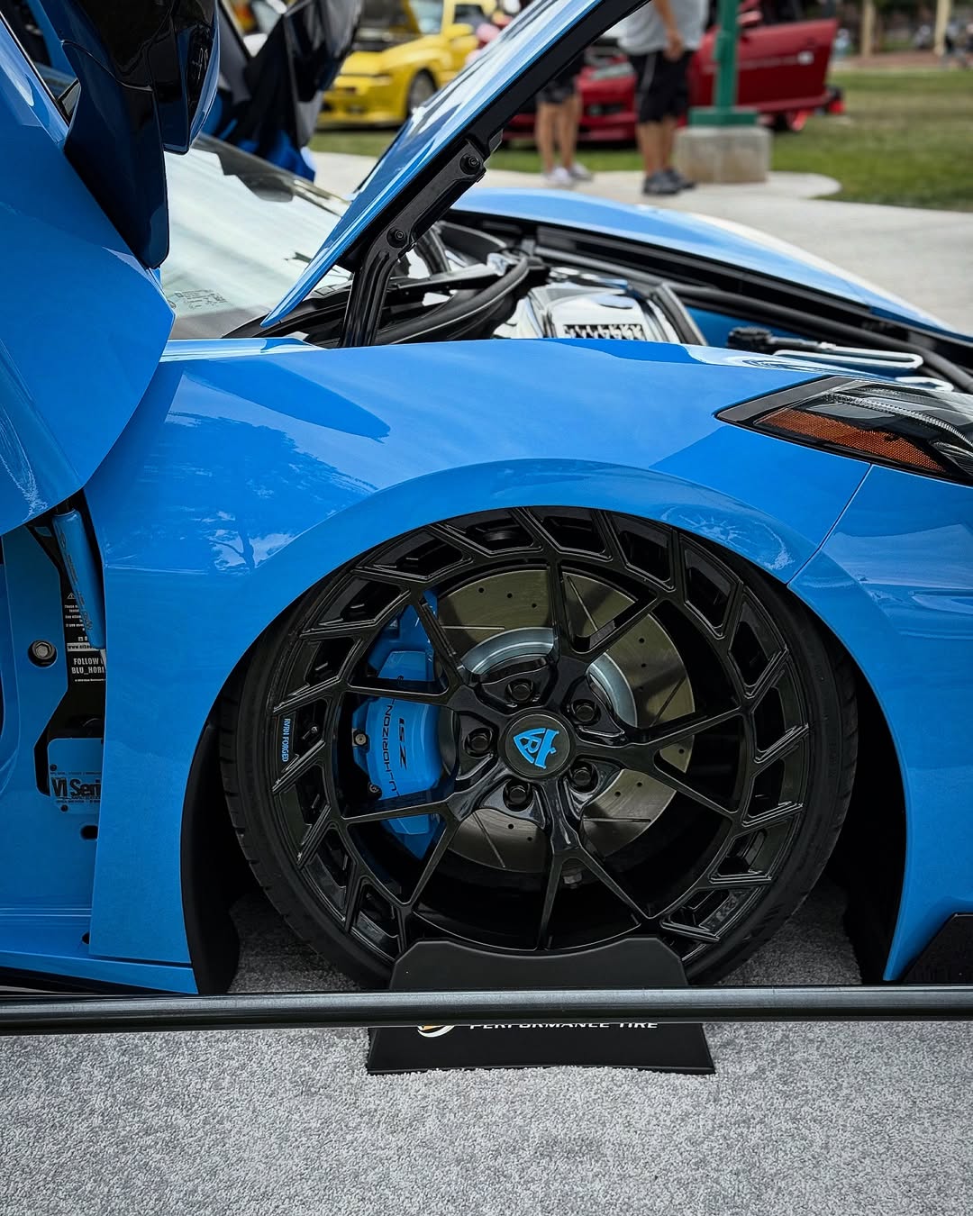 Blue Corvette C8 showcasing custom forged carbon flash wheels with detailed brake calipers.