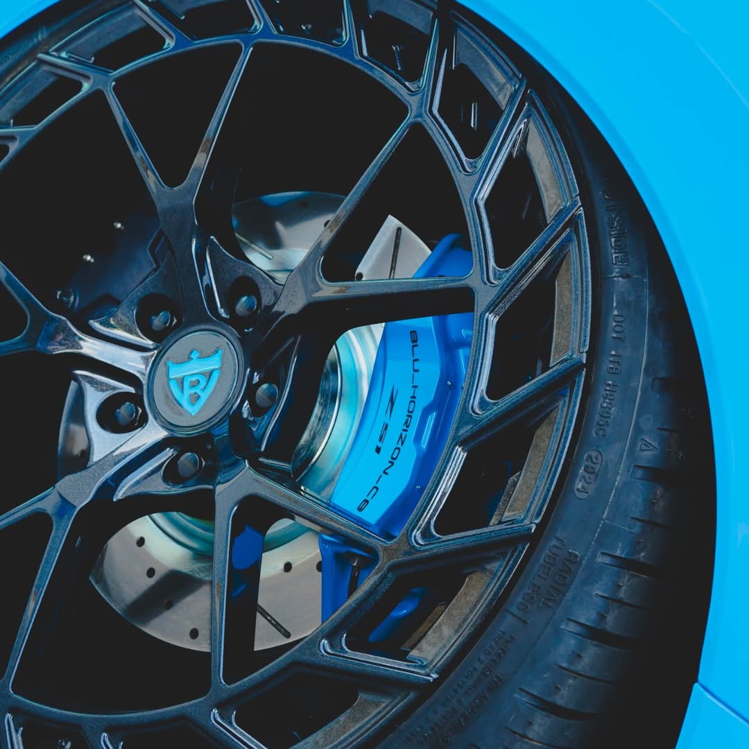 Close-up of custom forged Corvette C8 aftermarket wheel showcasing carbon flash finish and performance brake caliper.
