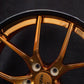 Detail shot of forged bronze Corvette wheels – center cap and lug area