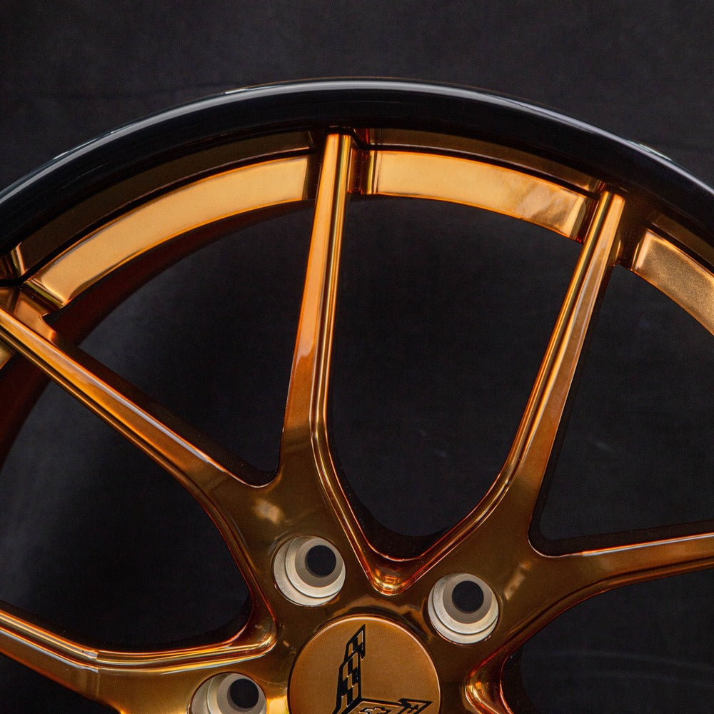 Detail shot of forged bronze Corvette wheels – center cap and lug area