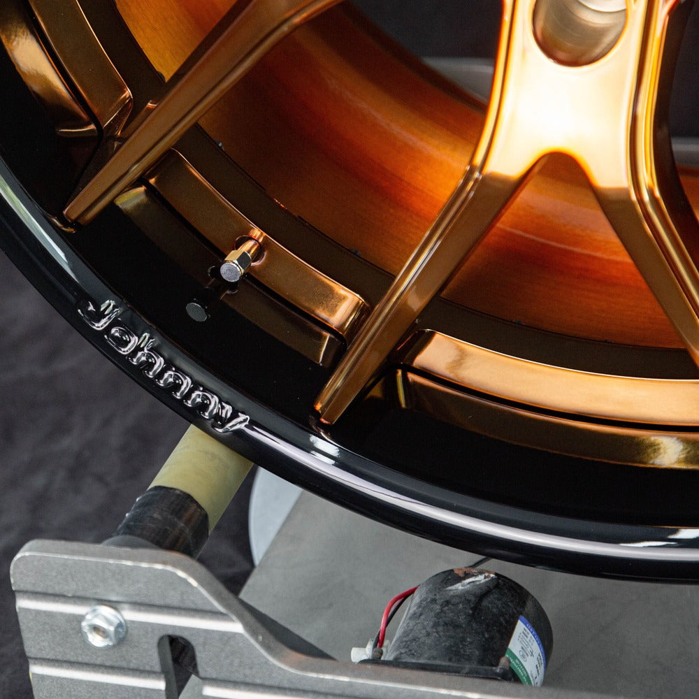 Detail shot of forged bronze Corvette wheels – center cap and lug area