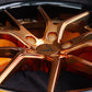 Detail shot of forged bronze Corvette wheels – center cap and lug area