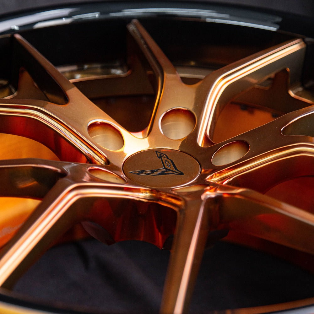 Detail shot of forged bronze Corvette wheels – center cap and lug area