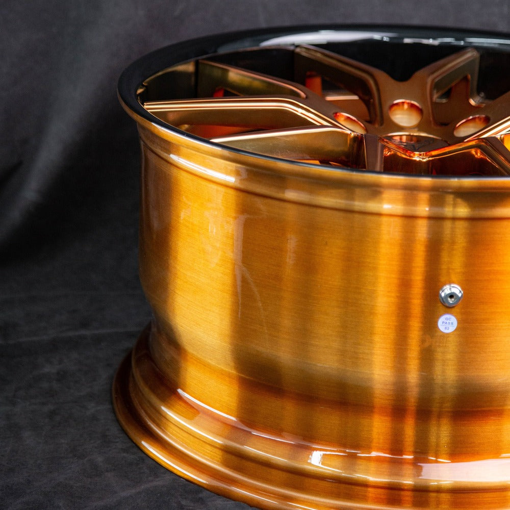 Detail shot of forged bronze Corvette wheels – center cap and lug area
