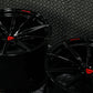 Glossy black custom forged Corvette C6 Z06 wheels with red accents, showcasing a sleek concave design.