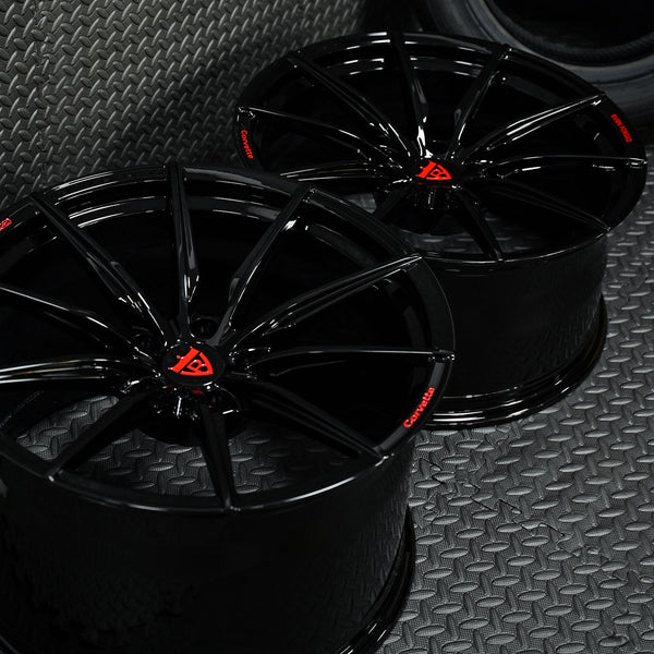 Custom forged Corvette C6 Z06 black wheels with a sleek design and red logo, showcasing high-quality craftsmanship.