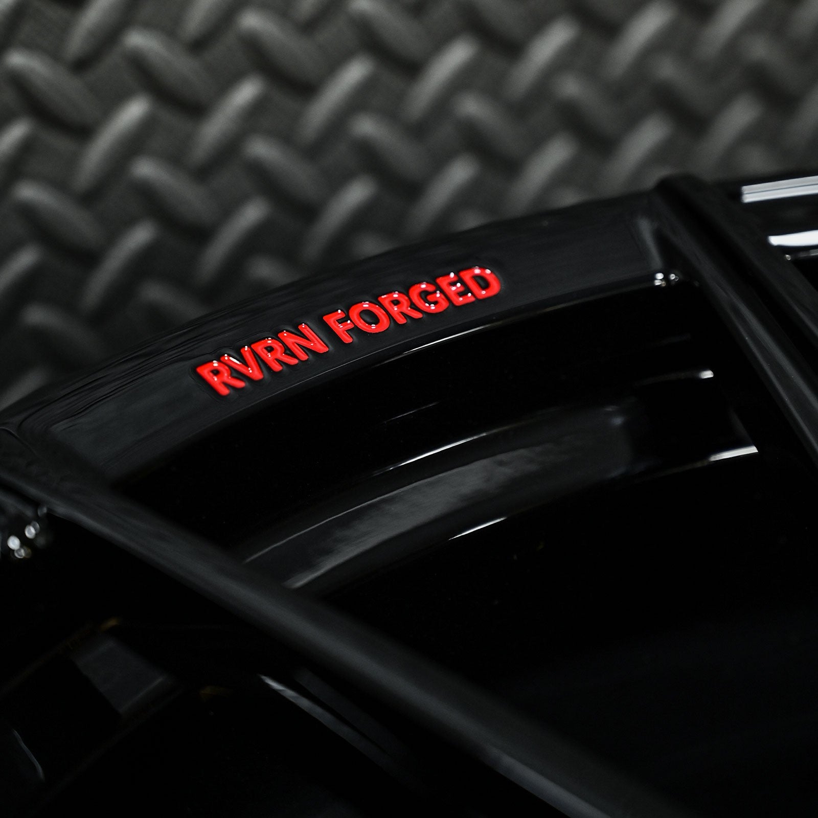 Close-up of RVRN Forged logo on custom black forged Corvette C6 Z06 wheel, showcasing high-quality craftsmanship.