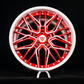 Custom forged red alloy wheel with intricate design and white lip, ideal for performance vehicles.