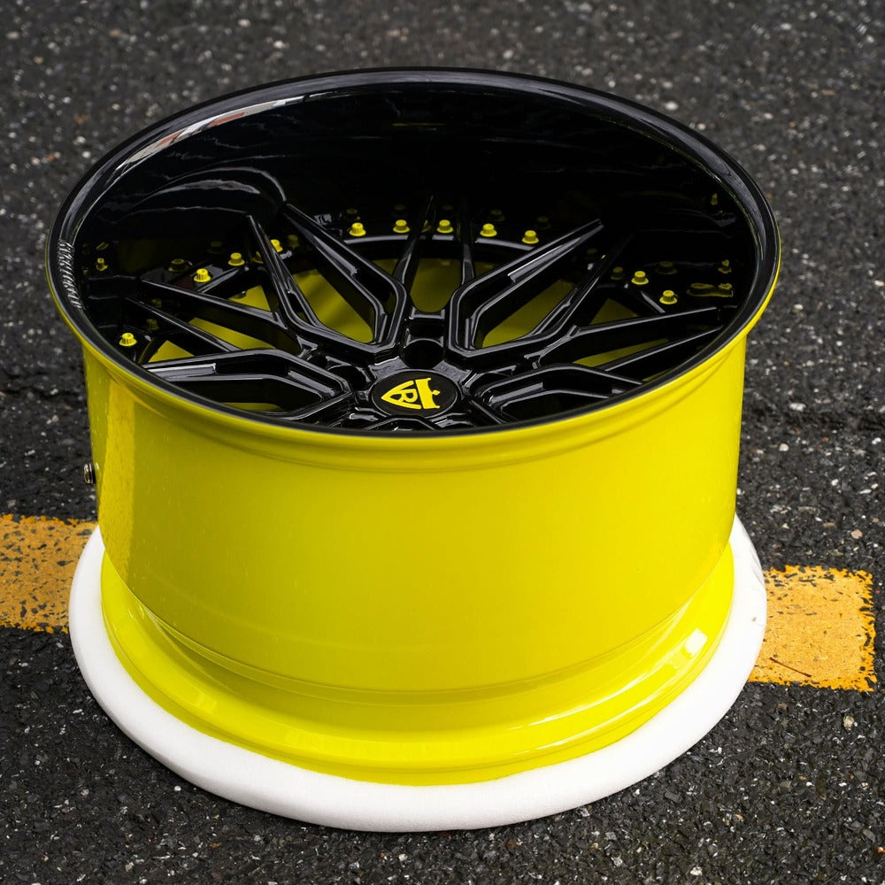 Close-up of yellow and gloss black forged Corvette wheel