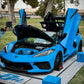 Custom blue Corvette C8 with open doors on display, showcasing aftermarket modifications and design.