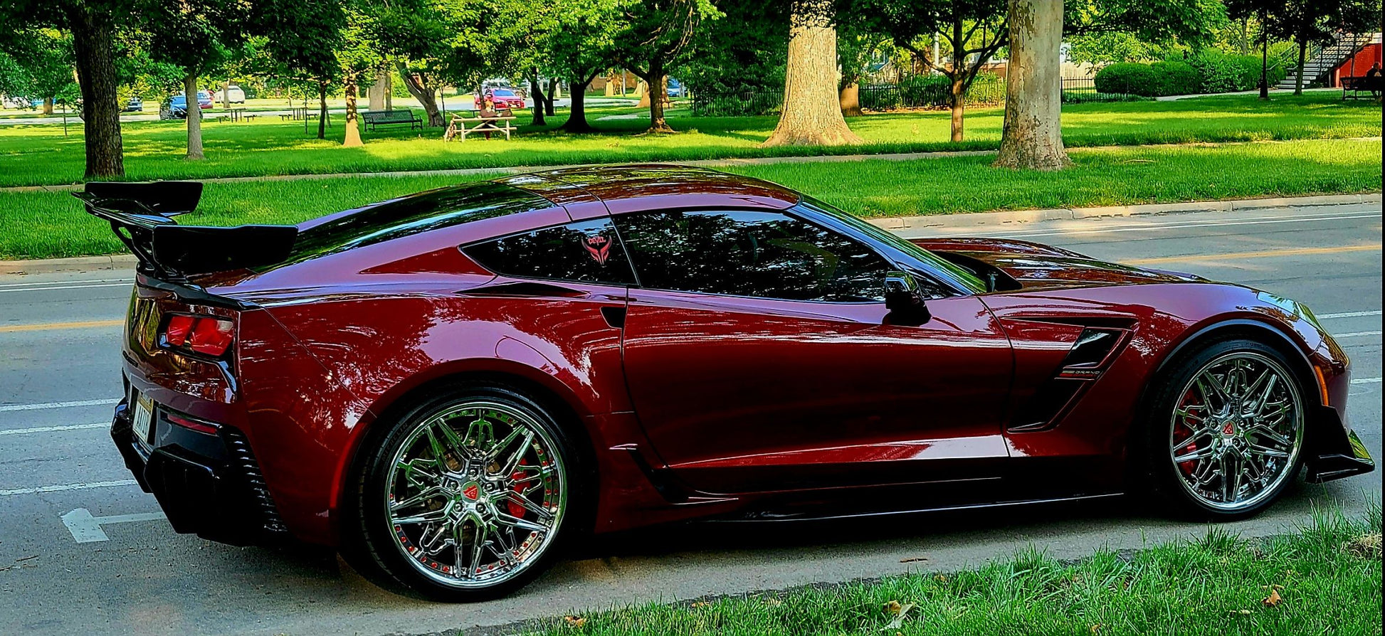 Aftermarket forged and chrome deep dish wheels for a red 2017 Corvette C7 Grand Sport models